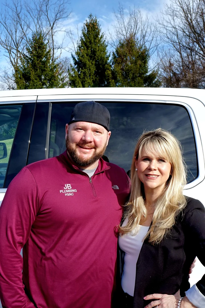 Co-owner Megan Blew with a JB Plumbing HVAC service truck on a Berks County maintenance call