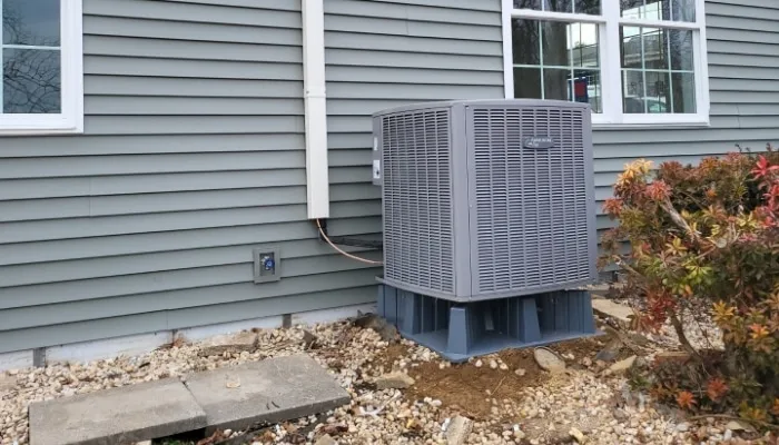 Replacement central AC condenser mounted on a raised composite platform