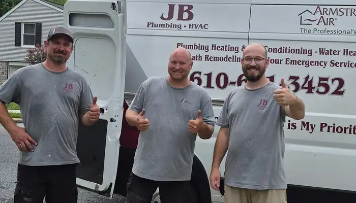 JB Plumbing HVAC technicians with a branded company service van in Reading PA