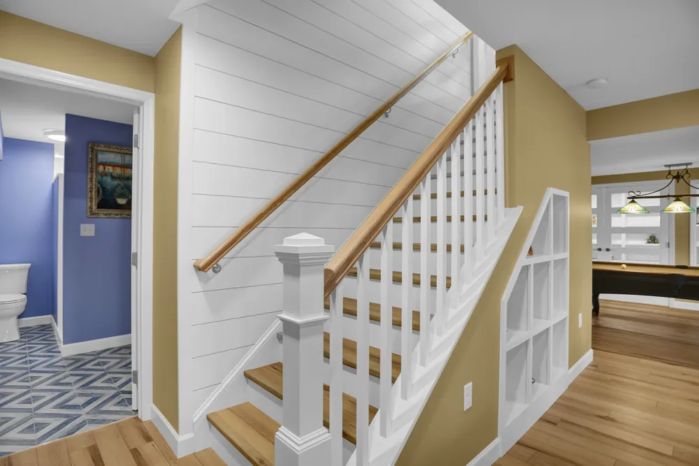 Subway tile accent detail on finished basement stairs by JB Plumbing HVAC